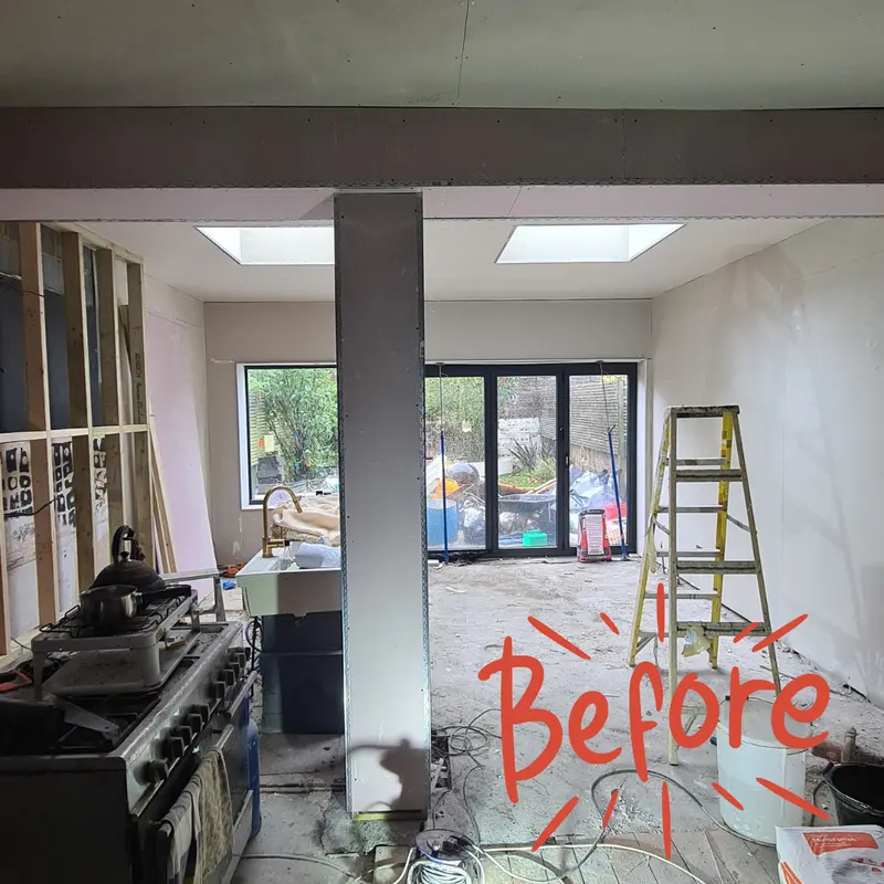 The same room stripped back to bare walls before work started