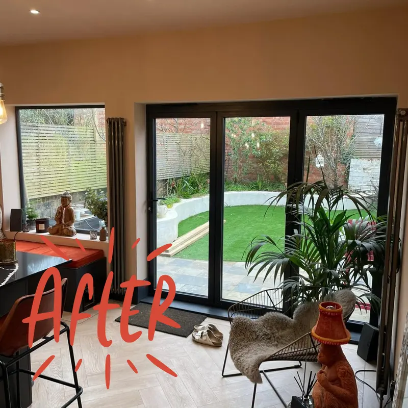 Finished extension with black bifold doors opening onto a lawn
