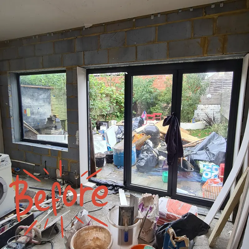 The same bifold doors set in bare blockwork during the build