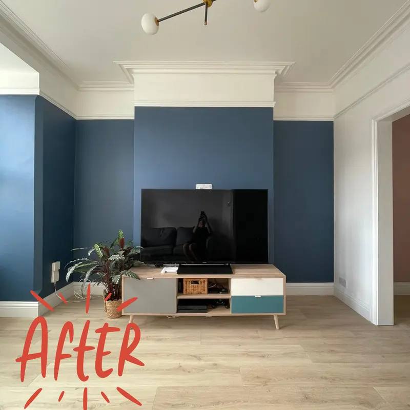 Finished chimney breast painted navy with a TV unit below