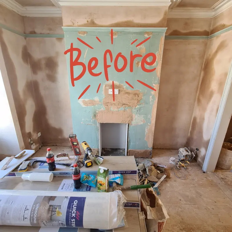 The same chimney breast stripped back with tools and materials on the floor