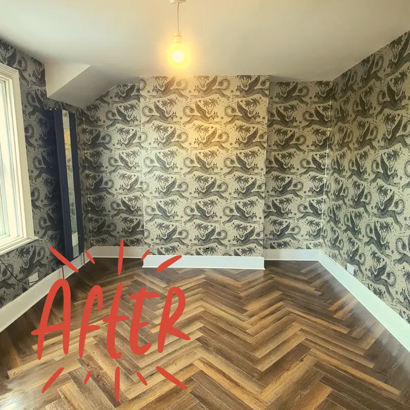 Finished room with patterned wallpaper and herringbone flooring