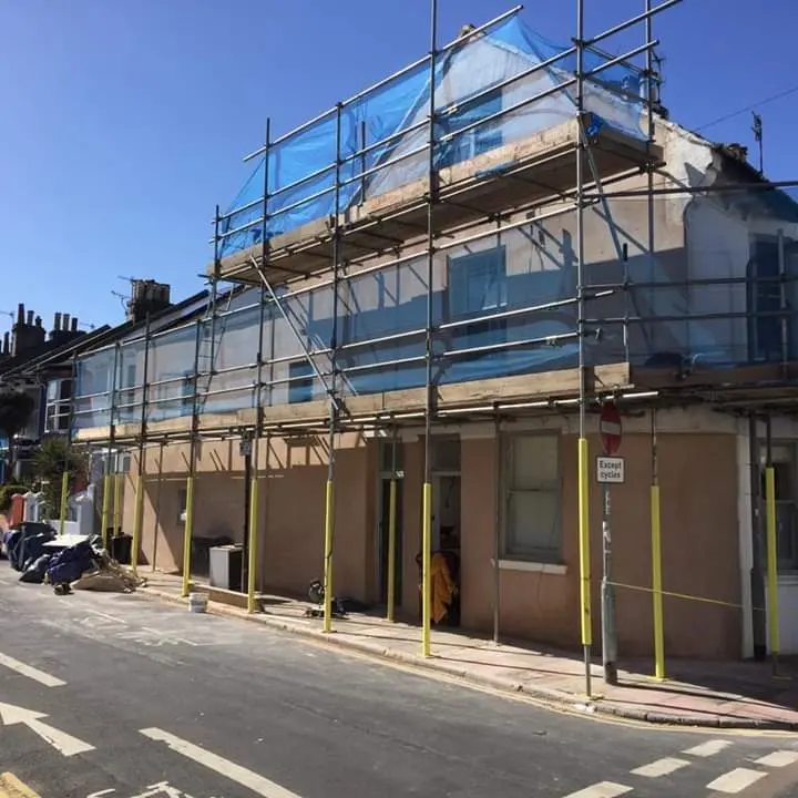 Terraced house wrapped in scaffolding for exterior works